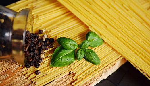 green leaves on top of uncooked pasta thumbnail