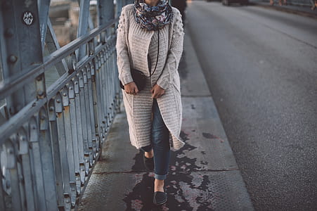 woman walking beside road near rail at daytime thumbnail