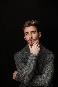 man in black knit long-sleeved shirt with black background thumbnail