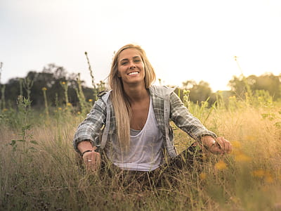 woman sitting on green grass field thumbnail