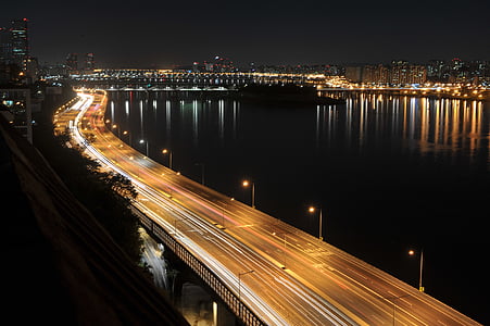 time lapse photography of vehicles on bridge thumbnail