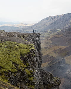 person standing on cliff at daytime thumbnail