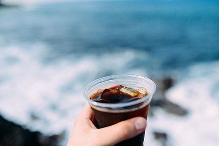 person holding clear cup thumbnail