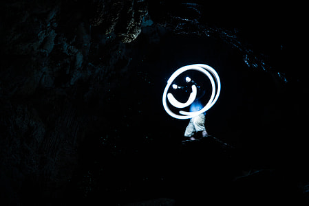 man standing inside cave photo thumbnail