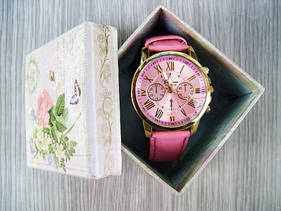 round gold-colored pink chronograph watch inside the box thumbnail