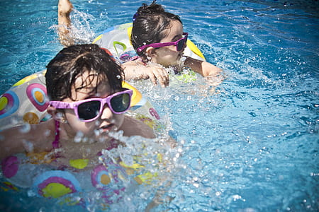two boy and girl with pink sunglasses swimming thumbnail