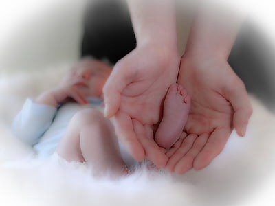 person holding baby foot thumbnail