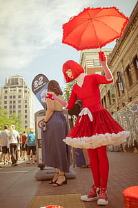 Woman Wearing Red Dress Holding Umbrella thumbnail