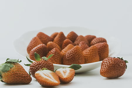 brown strawberries on white ceramic bowl thumbnail