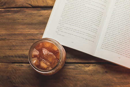 clear glass jar beside book on wooden board thumbnail