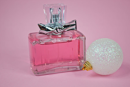 clear glass perfume bottle beside white bauble thumbnail