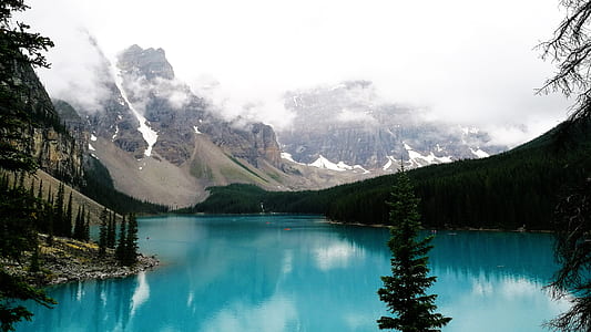 calm body of water between mountain thumbnail