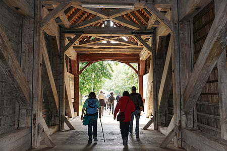 people walking on wooden tunnel thumbnail