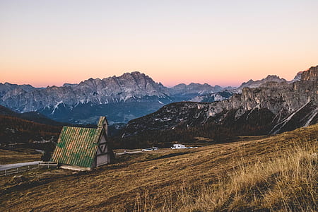 white and green house beside mountain thumbnail