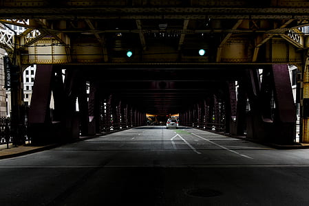 vehicle running on road under bridge during daytime thumbnail
