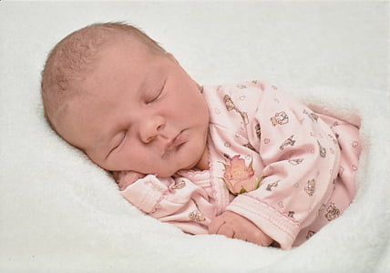 closeup photography of baby wearing pink sleeper thumbnail