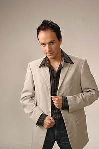 man standing while holding on coats thumbnail