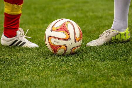 white and red soccer ball in field thumbnail
