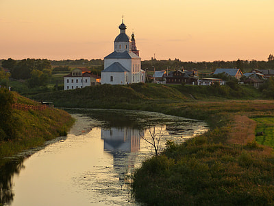 Landscape of church next to a river at dusk in Russia thumbnail