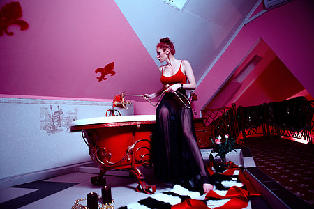 woman wearing red spaghetti strap top and black skirt thumbnail