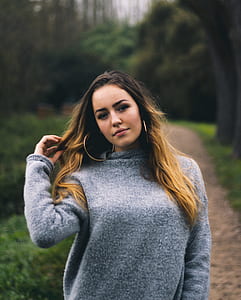 woman wearing gray sweater walking on pathway closeup photography thumbnail