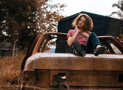 woman sitting on rusted abandoned cart thumbnail
