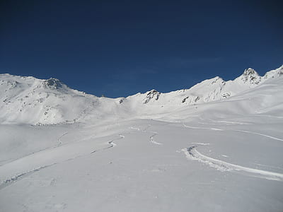 snow covered mountains under blue sky thumbnail