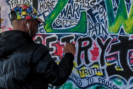 man painting on graffiti wall thumbnail