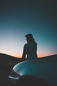 man sitting on car hood thumbnail