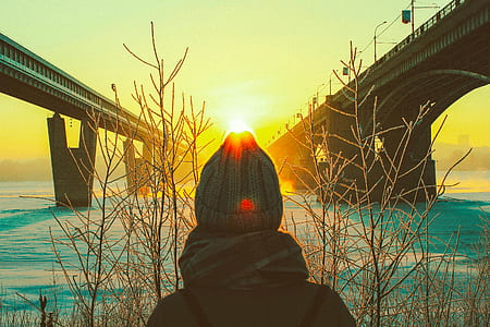 person wearing beanies under bridge during sunset thumbnail
