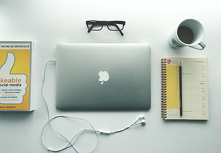 flat lay photography of silver MacBook beside spiral book and cup of coffee thumbnail