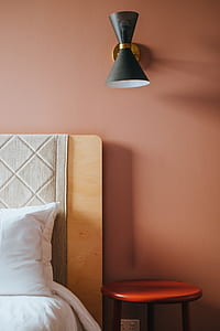 red wooden nightstand beside bed thumbnail