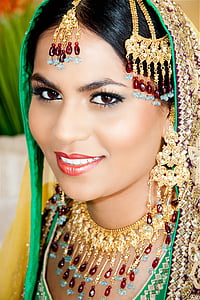woman wearing gold-colored red and blue gemstone jewelries thumbnail