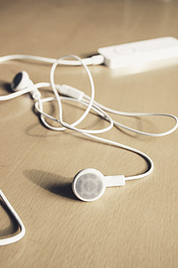 white earbuds on brown surface thumbnail