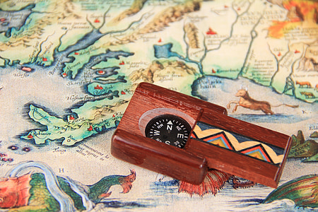 square black and brown compass on map thumbnail