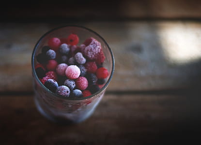 drinking glass full of red and black candy balls thumbnail