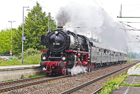 traveling black and red train near tree thumbnail