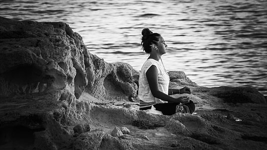 woman crossing her legs sitting near body of water thumbnail