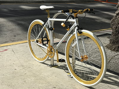 white bike at bike stand near street thumbnail