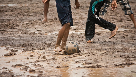 people playing soccer on mud thumbnail