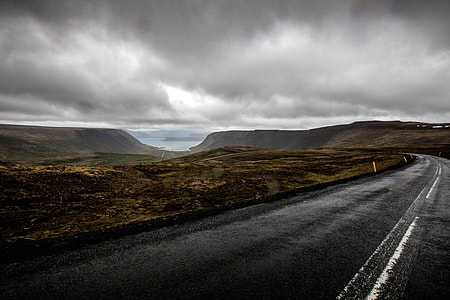 asphalt road under gray clouds during daytime thumbnail