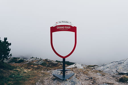 Grand Tour signage near cliff of mountain thumbnail