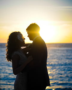 man and woman looking each other beside body of water thumbnail