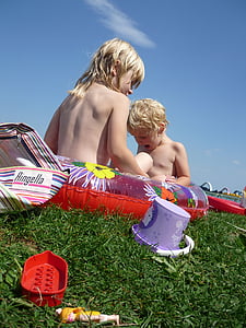worm's view of children on inflatable ring under calm sky thumbnail
