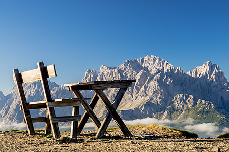 brown wooden table and chair on cliff thumbnail
