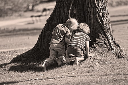two boys kneeling under tree thumbnail