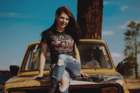 woman sitting on vehicle at daytime thumbnail