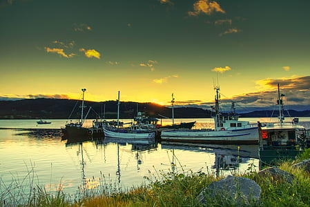 white and blue boats on body of water during golden houir thumbnail