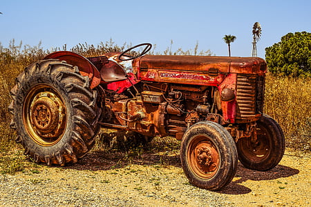 red and brown tractor near withered plant thumbnail