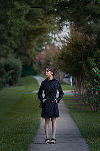 woman standing beside pine tree thumbnail
